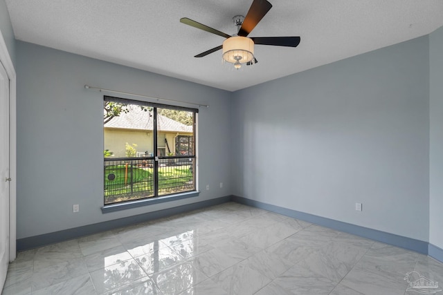 2715 Masters Blvd, Navarre, FL 32566 - spare room with light marble finish flooring, a ceiling fan, and a textured ceiling