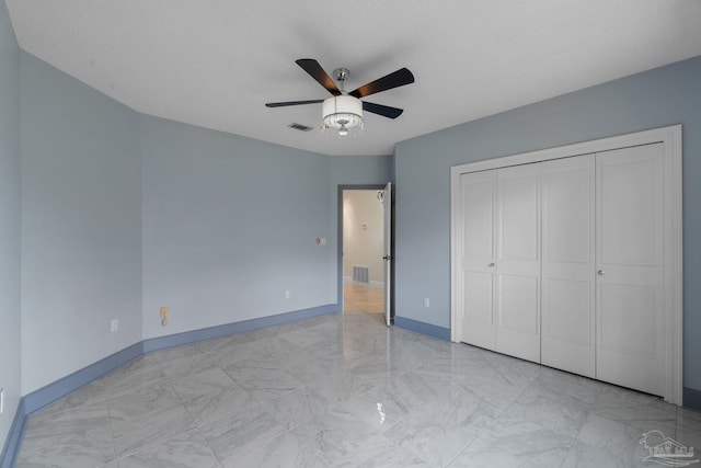 2715 Masters Blvd, Navarre, FL 32566 - unfurnished bedroom with a closet, marble finish flooring, and a ceiling fan