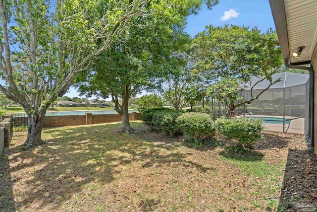 2715 Masters Blvd, Navarre, FL 32566 - fenced backyard with a water view, an outdoor pool, and a lanai