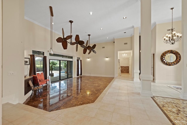 tiled entryway featuring a high ceiling, crown molding, and a notable chandelier