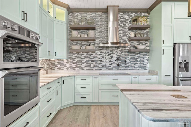 7730 Sunfish Ln, Milton, FL 32583 - kitchen with crown molding, open shelves, decorative backsplash, wall chimney range hood, and appliances with stainless steel finishes