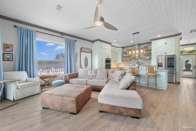 7730 Sunfish Ln, Milton, FL 32583 - living area with light wood finished floors, visible vents, ornamental molding, and a ceiling fan