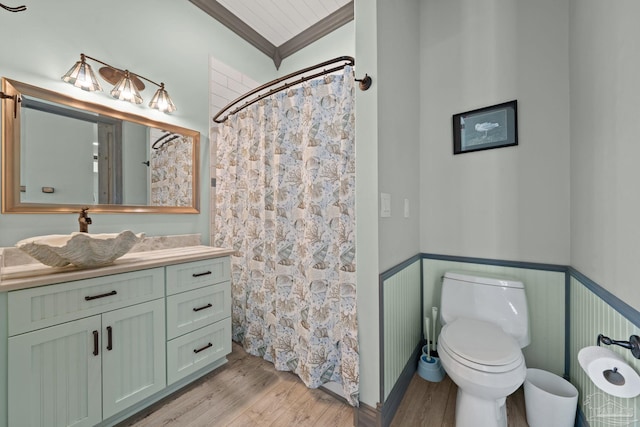 7730 Sunfish Ln, Milton, FL 32583 - bathroom featuring a wainscoted wall, crown molding, toilet, wood finished floors, and vanity