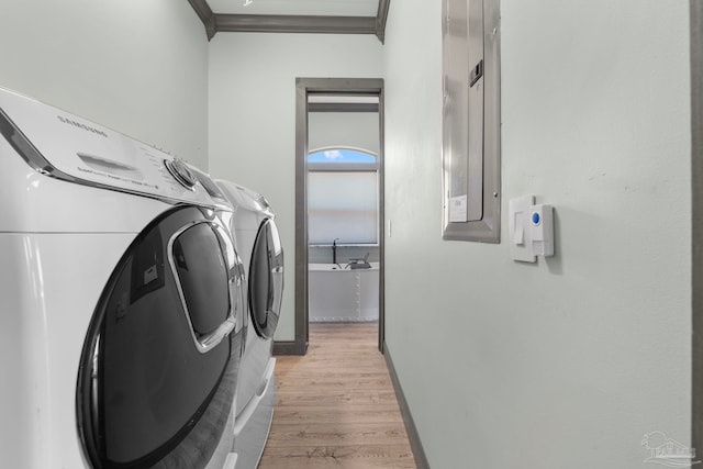 7730 Sunfish Ln, Milton, FL 32583 - washroom with ornamental molding, baseboards, light wood-style flooring, washing machine and dryer, and laundry area