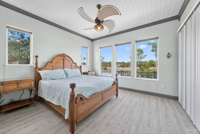 7730 Sunfish Ln, Milton, FL 32583 - bedroom with crown molding, multiple windows, light wood finished floors, and baseboards