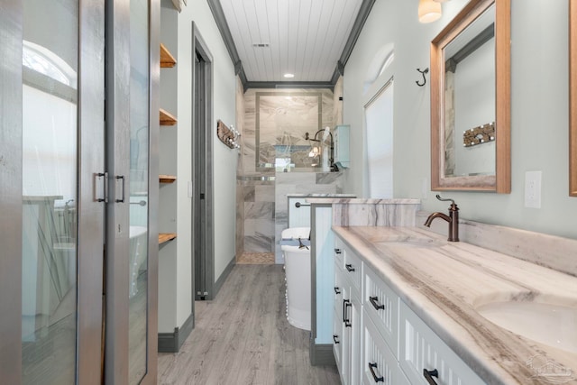 7730 Sunfish Ln, Milton, FL 32583 - full bathroom featuring crown molding, double vanity, wood finished floors, a sink, and a stall shower
