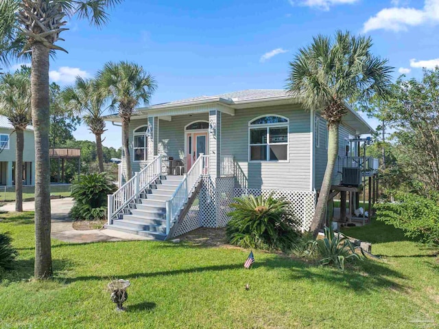 7730 Sunfish Ln, Milton, FL 32583 - view of front facade featuring central AC, a front lawn, stairway, and a porch