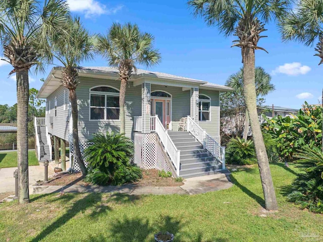 7730 Sunfish Ln, Milton, FL 32583 - view of front of home with covered porch, a front yard, and stairs