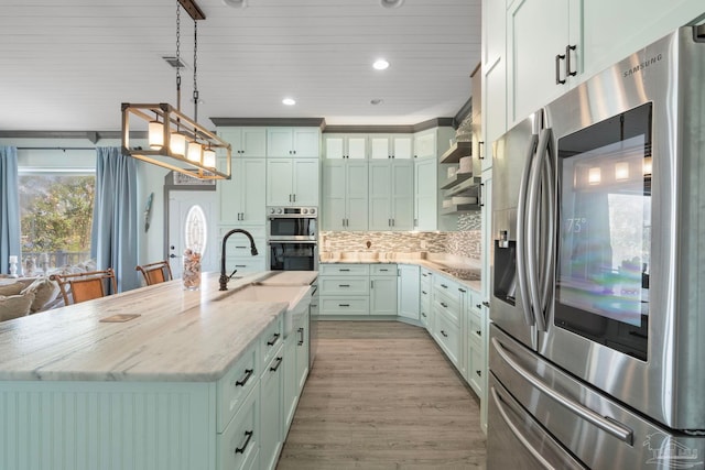 7730 Sunfish Ln, Milton, FL 32583 - kitchen with stainless steel appliances, light wood-type flooring, light stone counters, pendant lighting, and backsplash