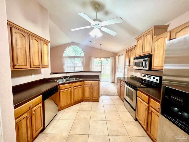 kitchen featuring lofted ceiling, light tile patterned floors, ceiling fan, appliances with stainless steel finishes, and sink