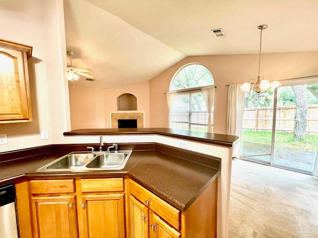 kitchen featuring ceiling fan with notable chandelier, sink, dishwasher, light colored carpet, and lofted ceiling