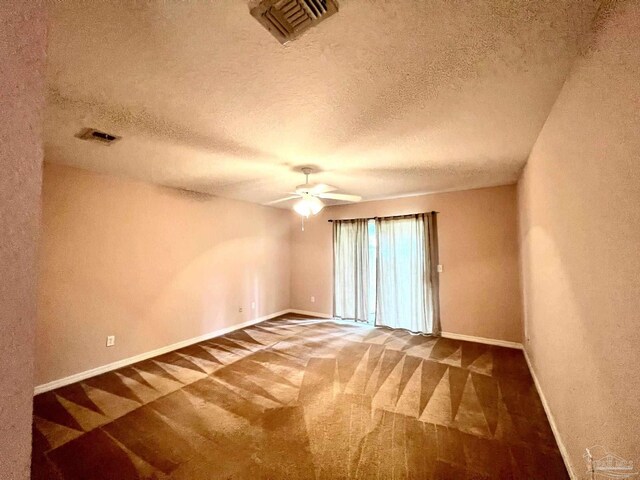 spare room with carpet flooring, a textured ceiling, and ceiling fan