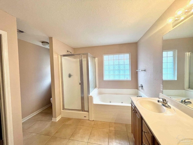 full bathroom featuring shower with separate bathtub, toilet, vanity, and a textured ceiling