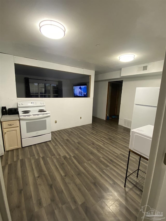 kitchen featuring dark hardwood / wood-style flooring and white appliances