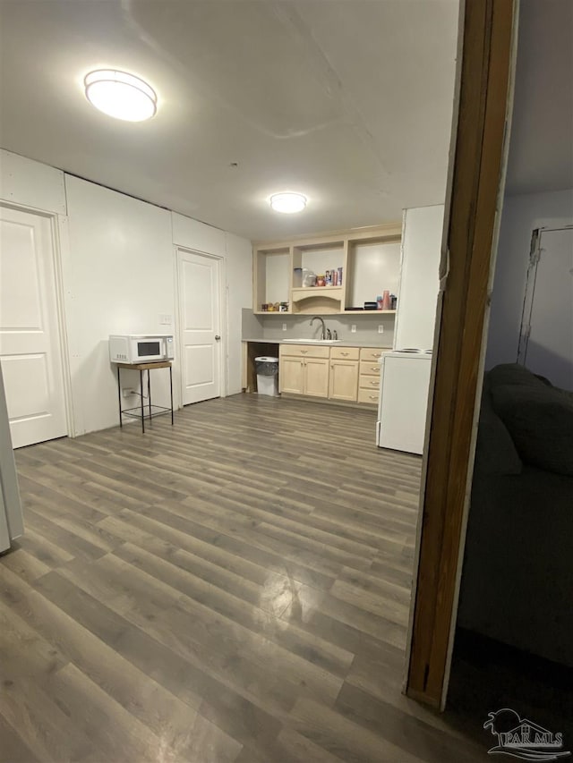 interior space with sink and dark wood-type flooring