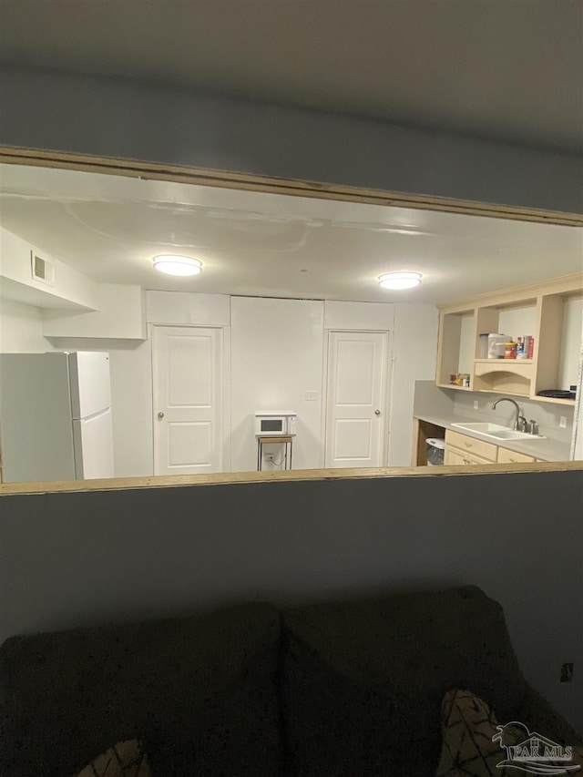 room details featuring white fridge and sink