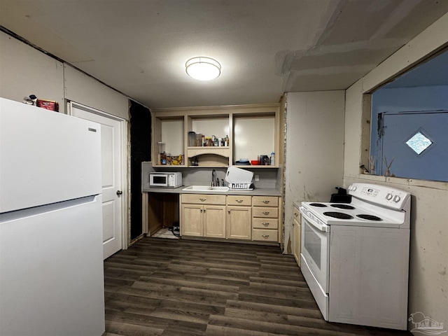 kitchen with sink, dark hardwood / wood-style floors, and white appliances