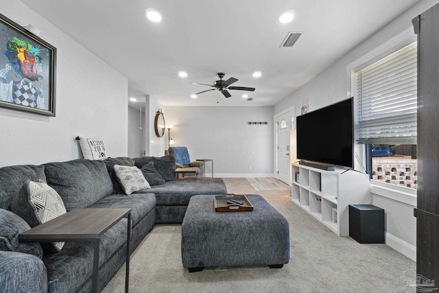 carpeted living room with ceiling fan