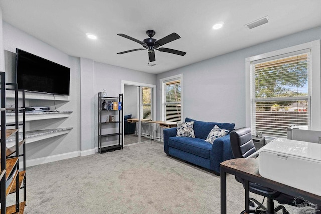 carpeted home office with a healthy amount of sunlight and ceiling fan