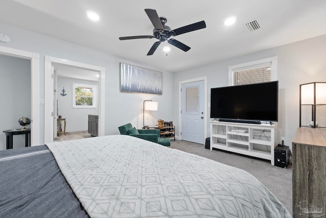 bedroom featuring light carpet and ceiling fan