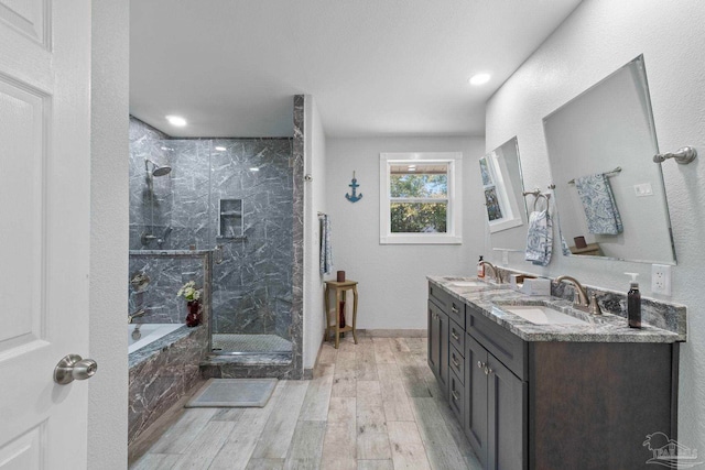 bathroom featuring vanity, separate shower and tub, and hardwood / wood-style floors