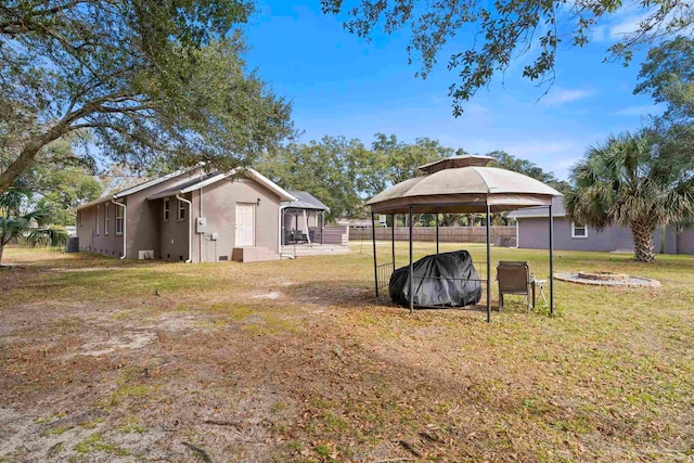 view of yard with a fire pit and a gazebo