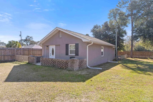 back of house with a lawn