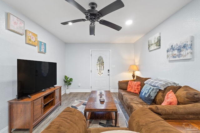 living room with ceiling fan and light wood-type flooring