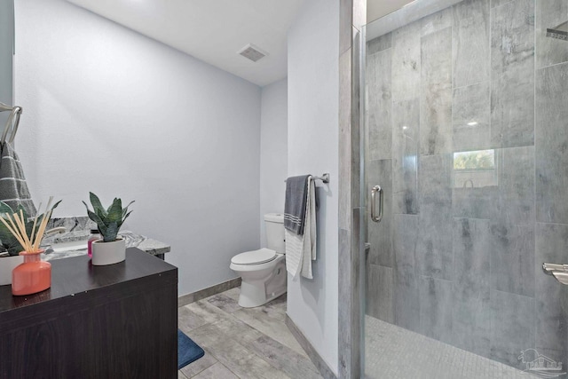 bathroom with toilet and a shower with shower door