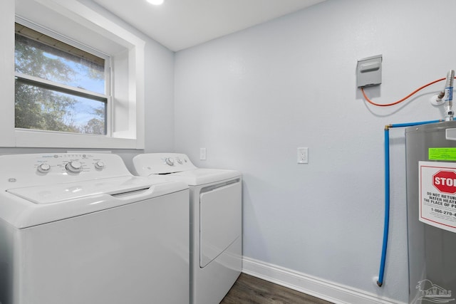 laundry area with water heater, washer and dryer, and dark hardwood / wood-style flooring