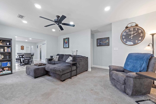 living room featuring light carpet and ceiling fan