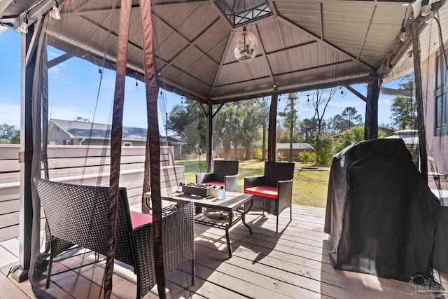 wooden deck featuring a gazebo and outdoor lounge area