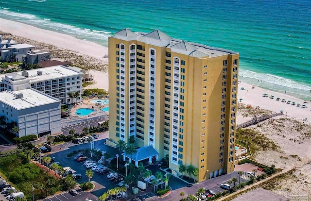 drone / aerial view featuring a beach view and a water view