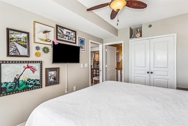 bedroom featuring a closet, baseboards, and ceiling fan