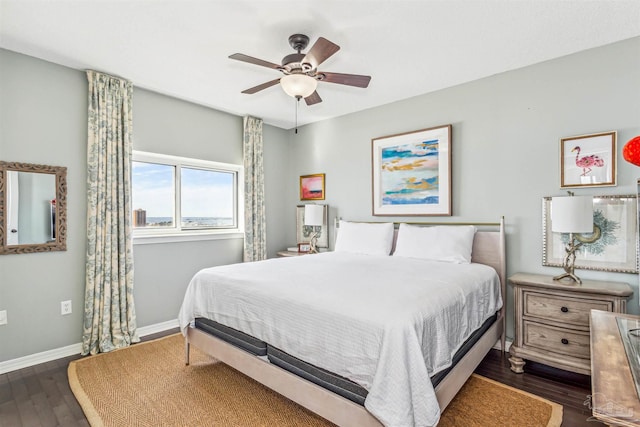 bedroom featuring baseboards, ceiling fan, and dark wood finished floors