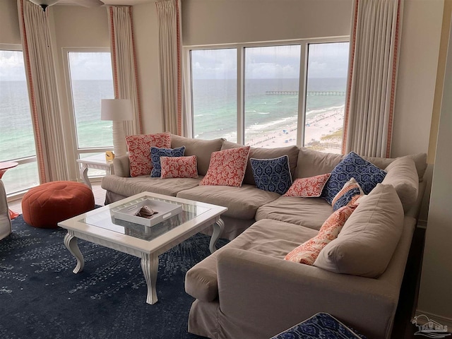 living room with a view of the beach and a water view