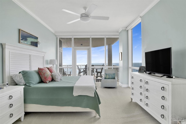 carpeted bedroom featuring ornamental molding, ceiling fan, access to exterior, and a wall of windows