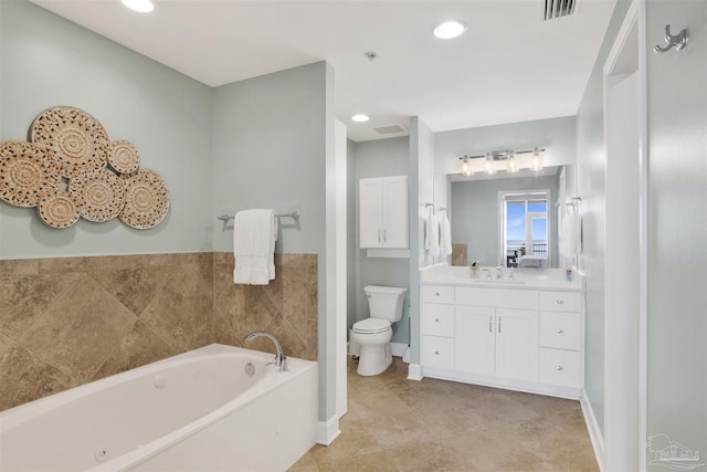 bathroom featuring a washtub, vanity, and toilet