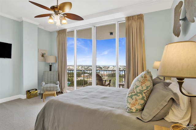 bedroom with expansive windows, ceiling fan, ornamental molding, and carpet floors