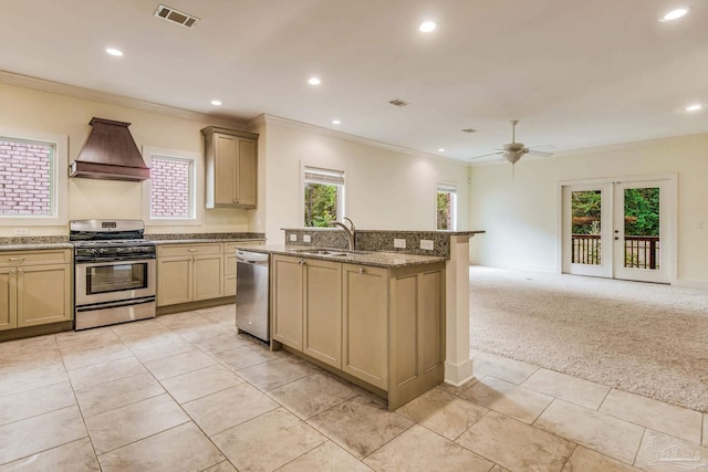 kitchen with light carpet, french doors, custom range hood, stainless steel appliances, and ceiling fan