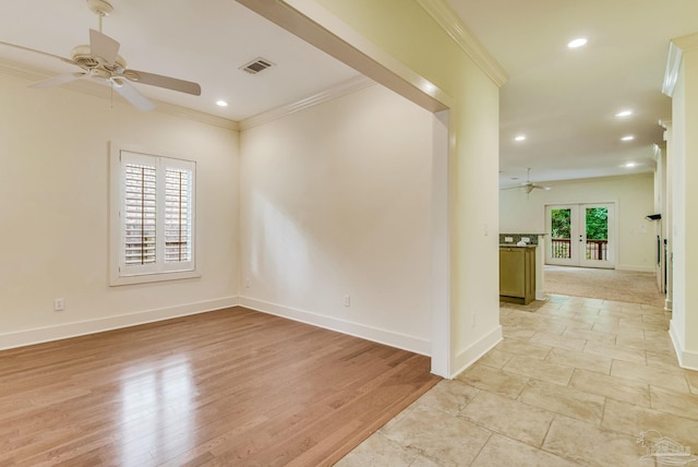 spare room featuring ceiling fan, light hardwood / wood-style floors, ornamental molding, and french doors