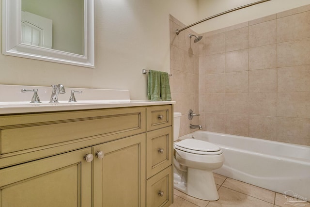 full bathroom featuring tile patterned floors, tiled shower / bath combo, toilet, and vanity