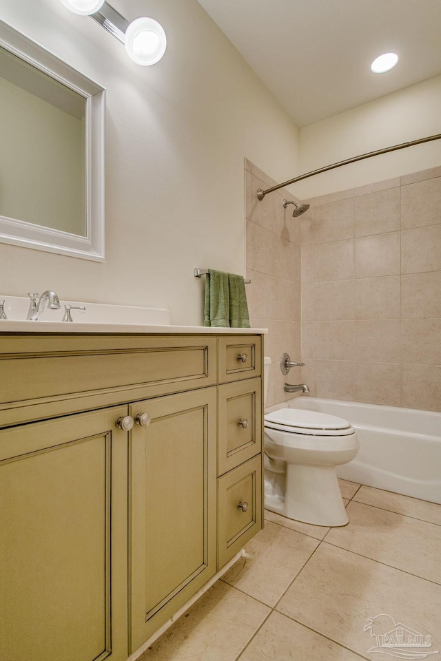 full bathroom with tile patterned floors, tiled shower / bath combo, toilet, and vanity