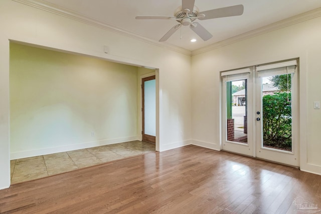 empty room with light wood-type flooring, ceiling fan, and ornamental molding