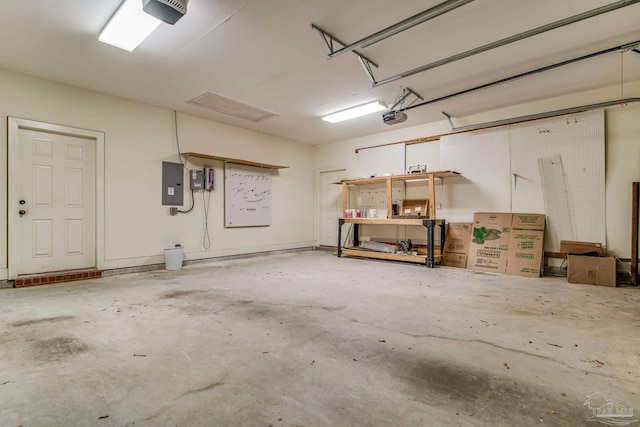 garage with a garage door opener and electric panel