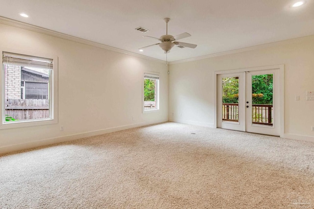 unfurnished room featuring carpet, french doors, plenty of natural light, and crown molding