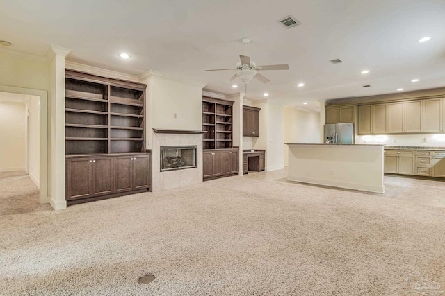 unfurnished living room with light carpet, ceiling fan, and ornamental molding