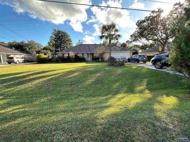 view of front of property featuring a garage and a front lawn