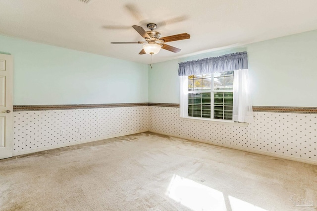 unfurnished room with ceiling fan and carpet floors