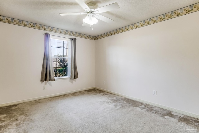 spare room with carpet, a textured ceiling, and ceiling fan